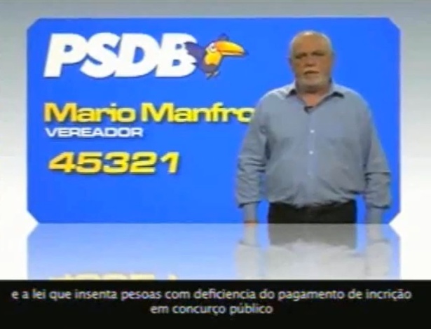 Reprodução mostra legenda de propaganda do vereador Mario Manfro (PSDB) com erros de português como "insenta", "deficiencia", "incrição" e "concurço". O anúncio foi mostrado na TV na última terça-feira (21)