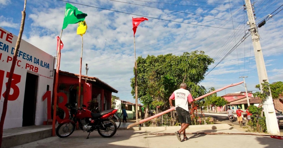 19.set.2012 - Homem carrega suporte que será usado para fixar bandeiras em Ilha Grande, no Piauí